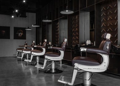 Chic barber chairs at Chaps & Co - Reform at the Lakes in Dubai, Dubai, AE, offering premium grooming services.