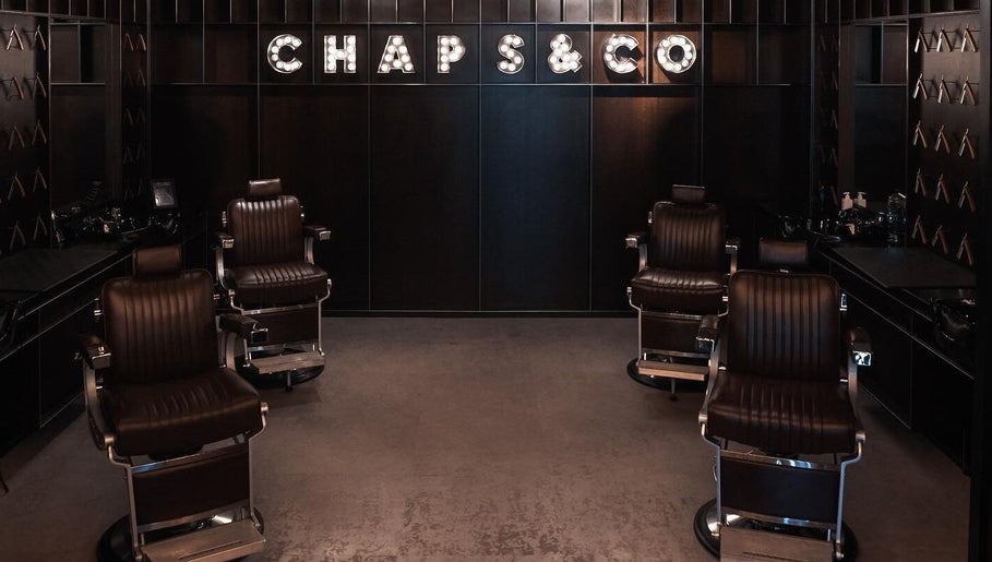 Elegant barber chairs inside Chaps & Co Yas Mall, Abu Dhabi, AE, showcasing sleek modern design.