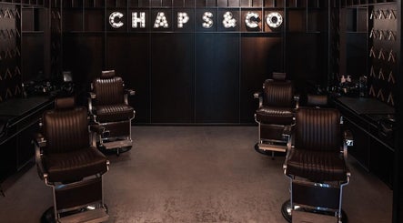 Elegant barber chairs inside Chaps & Co Yas Mall, Abu Dhabi, AE, showcasing sleek modern design.