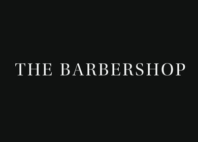 Elegant signage for The Barbershop at Harvey Nichols, located in Dubai, Dubai, AE. Sleek black background.