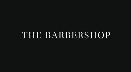 Elegant signage for The Barbershop at Harvey Nichols, located in Dubai, Dubai, AE. Sleek black background.