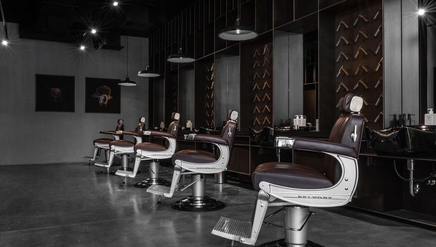 Modern barbershop interior at Chaps & Co - Reform at the Lakes in Dubai, Dubai, AE featuring sleek chairs.