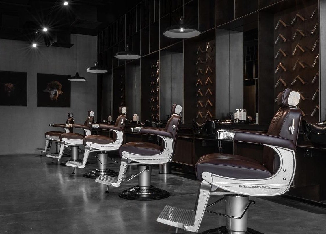 Modern barbershop interior at Chaps & Co - Reform at the Lakes in Dubai, Dubai, AE featuring sleek chairs.