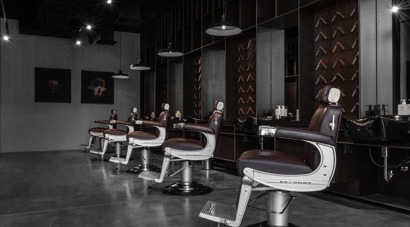 Modern barbershop interior at Chaps & Co - Reform at the Lakes in Dubai, Dubai, AE featuring sleek chairs.