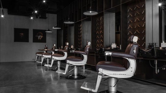 Modern barbershop interior at Chaps & Co - Reform at the Lakes in Dubai, Dubai, AE featuring sleek chairs.