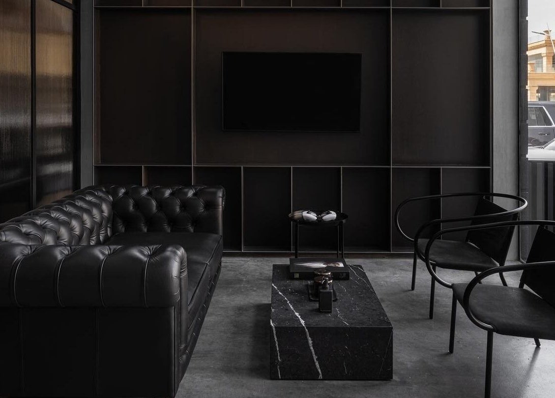 Sophisticated lounge at Chaps & Co - Reform at the Lakes, Dubai, Dubai, AE, featuring a black leather sofa.
