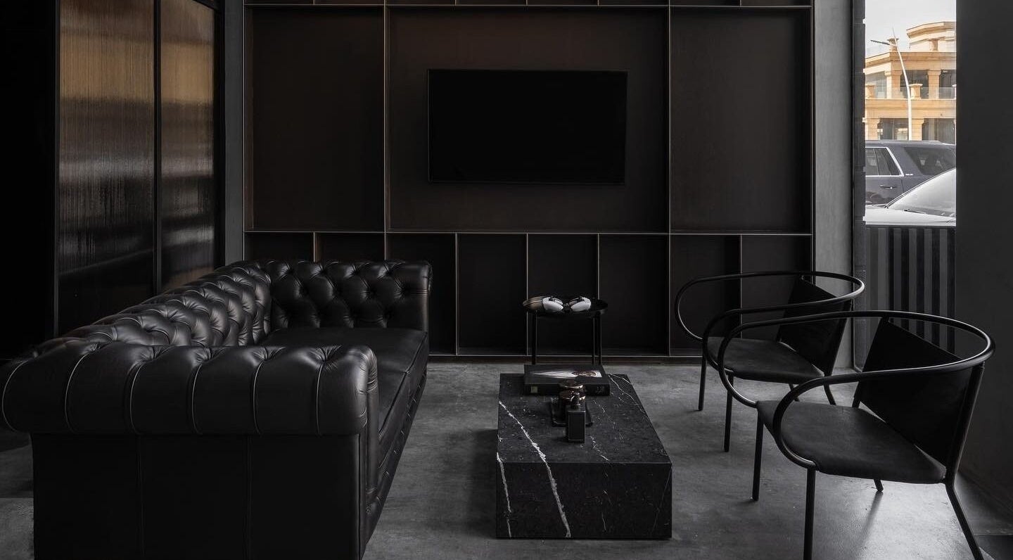 Sophisticated lounge at Chaps & Co - Reform at the Lakes, Dubai, Dubai, AE, featuring a black leather sofa.