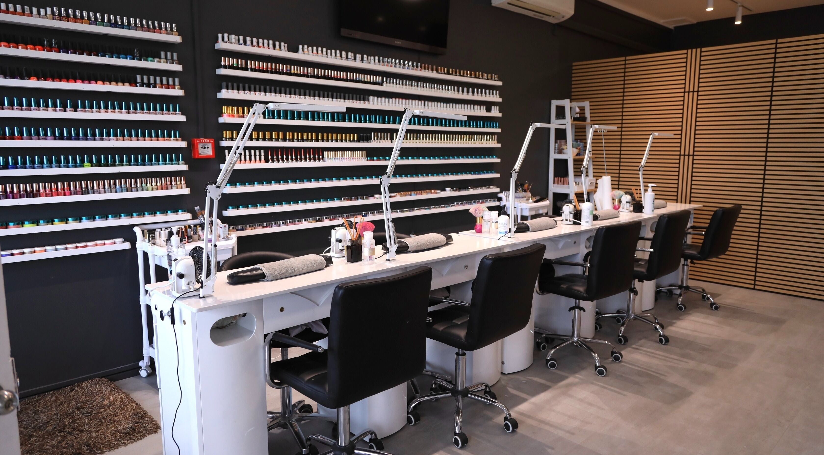 Sleek nail stations at Dream Nail & Spa, Auckland, NZ, showcasing an array of vibrant polishes.
