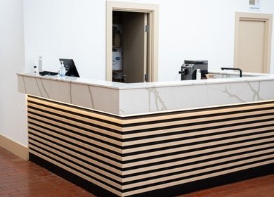 Stylish reception desk at ZONE RECOVERY in London, England, GB, featuring minimalist design.