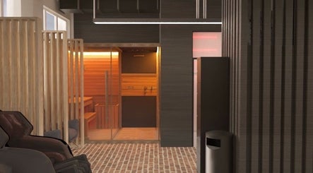 Warm sauna interior at ZONE RECOVERY, London, England, GB offering a cozy relaxation space.