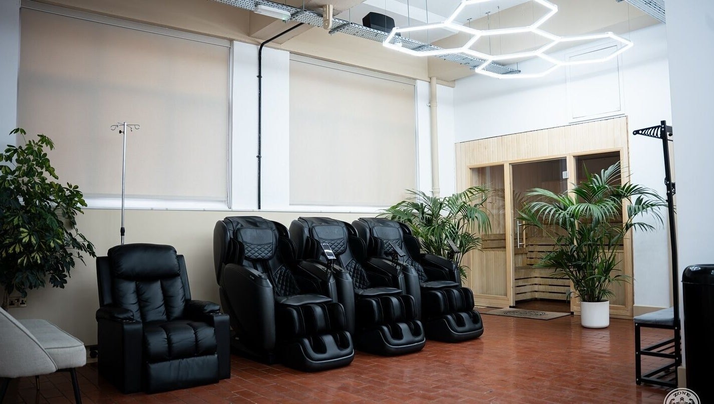 Massage chairs and sauna at ZONE RECOVERY in London, England, GB providing wellness and relaxation.