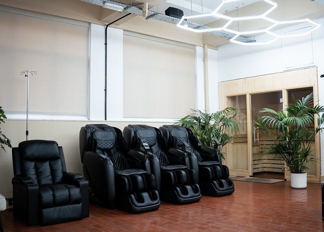 Massage chairs and sauna at ZONE RECOVERY in London, England, GB providing wellness and relaxation.
