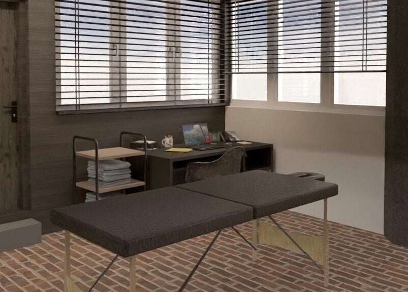 Modern therapy room at ZONE RECOVERY, London, England, GB, featuring a massage table and cozy decor.
