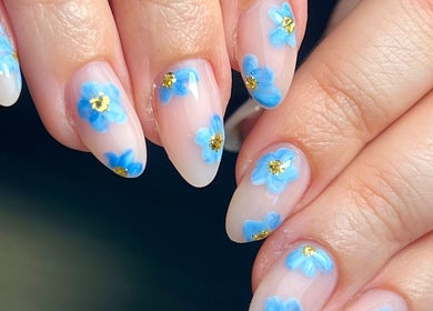 Close-up of blue floral nail art at Beauty By Phoebs in Reigate, England, GB.