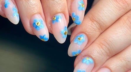 Close-up of blue floral nail art at Beauty By Phoebs in Reigate, England, GB.