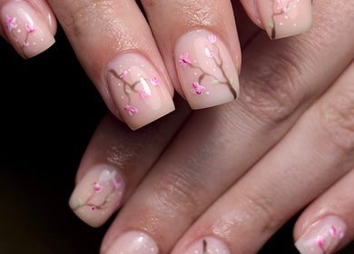 Elegant floral nail art at Beauty By Phoebs, Reigate, England, GB offers cherry blossom designs.