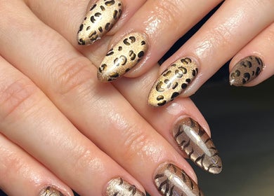 Glossy gold leopard print nails at Beauty By Phoebs in Reigate, England, GB, perfect for elegant style.