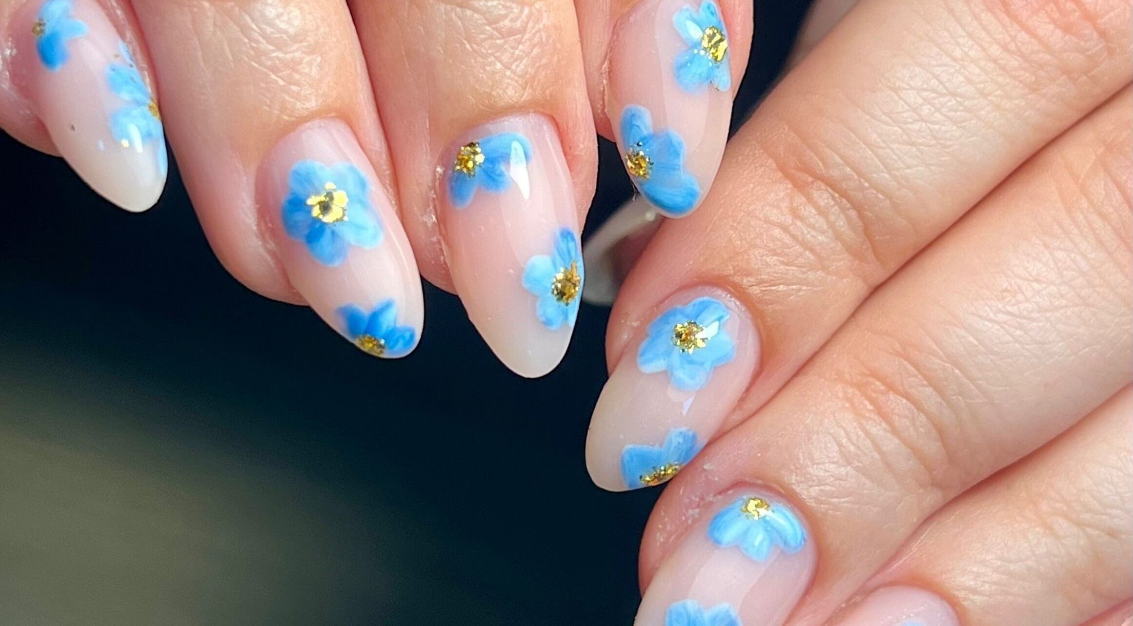 Close-up of blue floral nail art at Beauty By Phoebs - Hackney, London, England, GB.