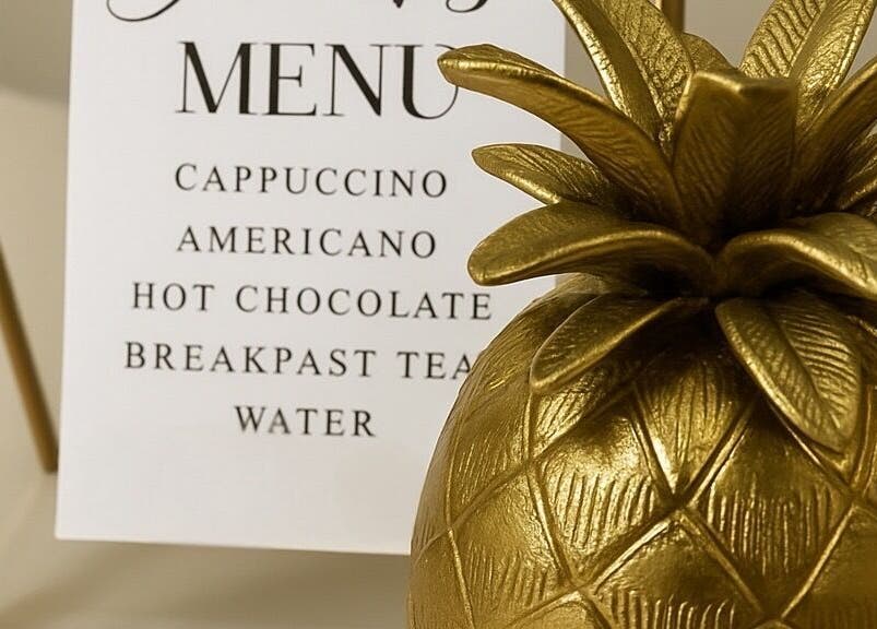 Elegant drinks menu and gold pineapple at Rebecca Gladman Aesthetics, Kings Langley, England, GB.