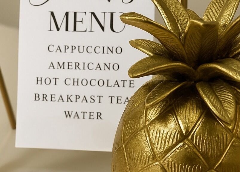 Elegant drinks menu and gold pineapple at Rebecca Gladman Aesthetics, Kings Langley, England, GB.