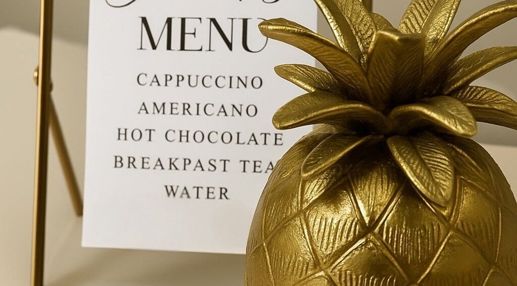 Elegant drinks menu and gold pineapple at Rebecca Gladman Aesthetics, Kings Langley, England, GB.