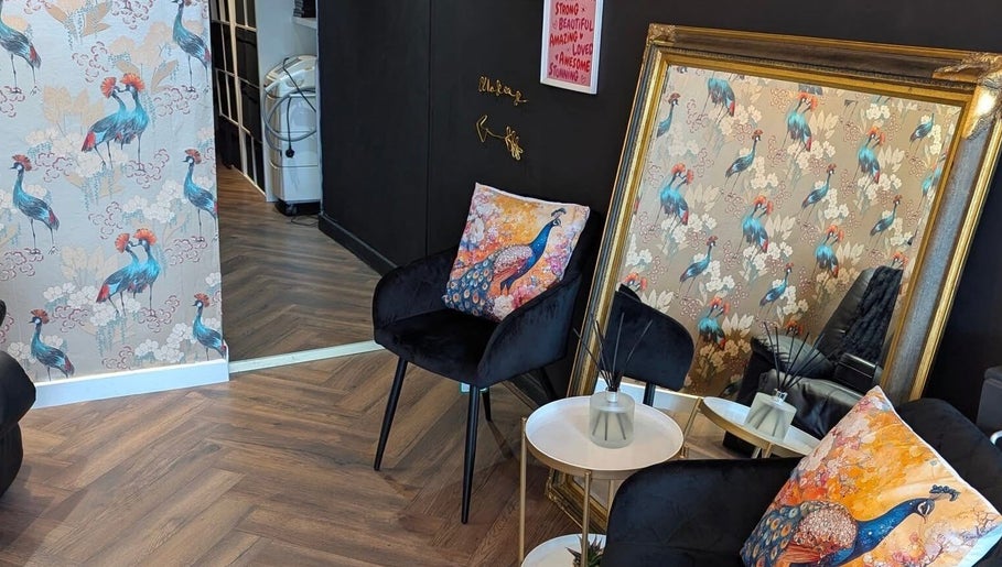 Stylish lounge area at Victoria Jane Makeup, Glasgow, Scotland, GB with peacock decor and elegant mirror.