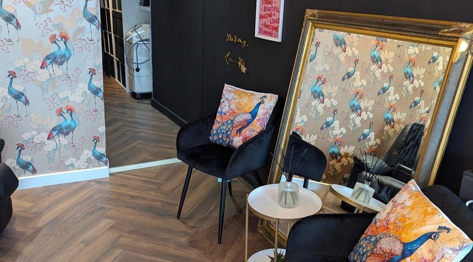 Stylish lounge area at Victoria Jane Makeup, Glasgow, Scotland, GB with peacock decor and elegant mirror.