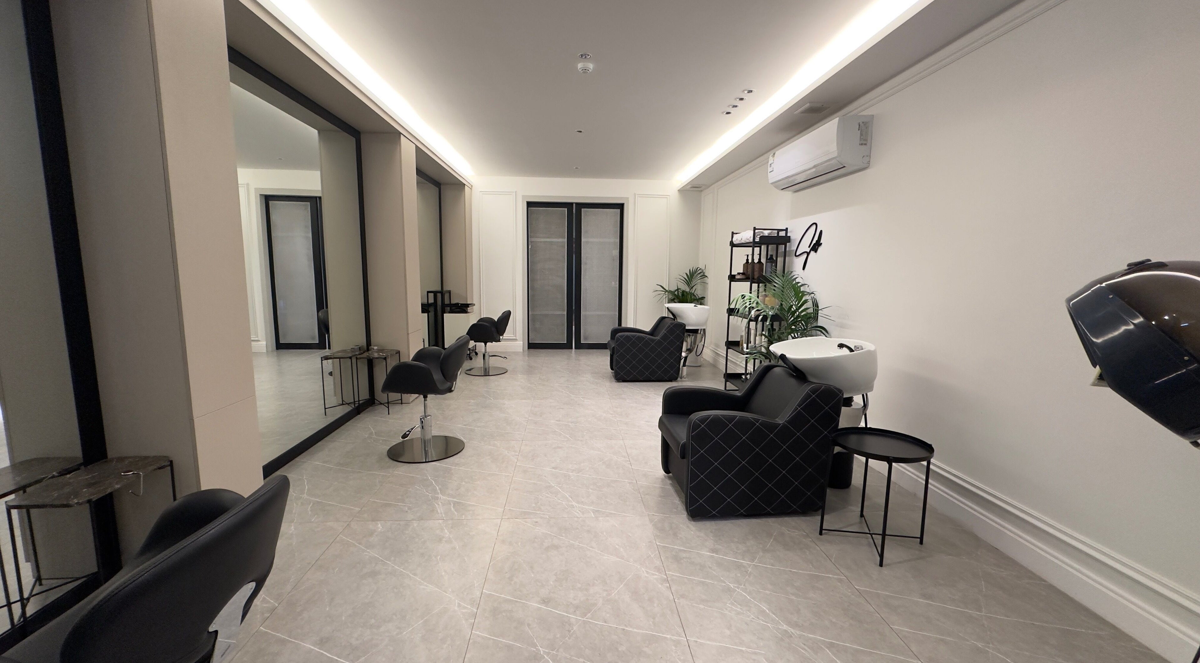 Modern salon interior at Sw Salon, Riyadh, Riyadh Province, SA, featuring chic black chairs and mirrors.