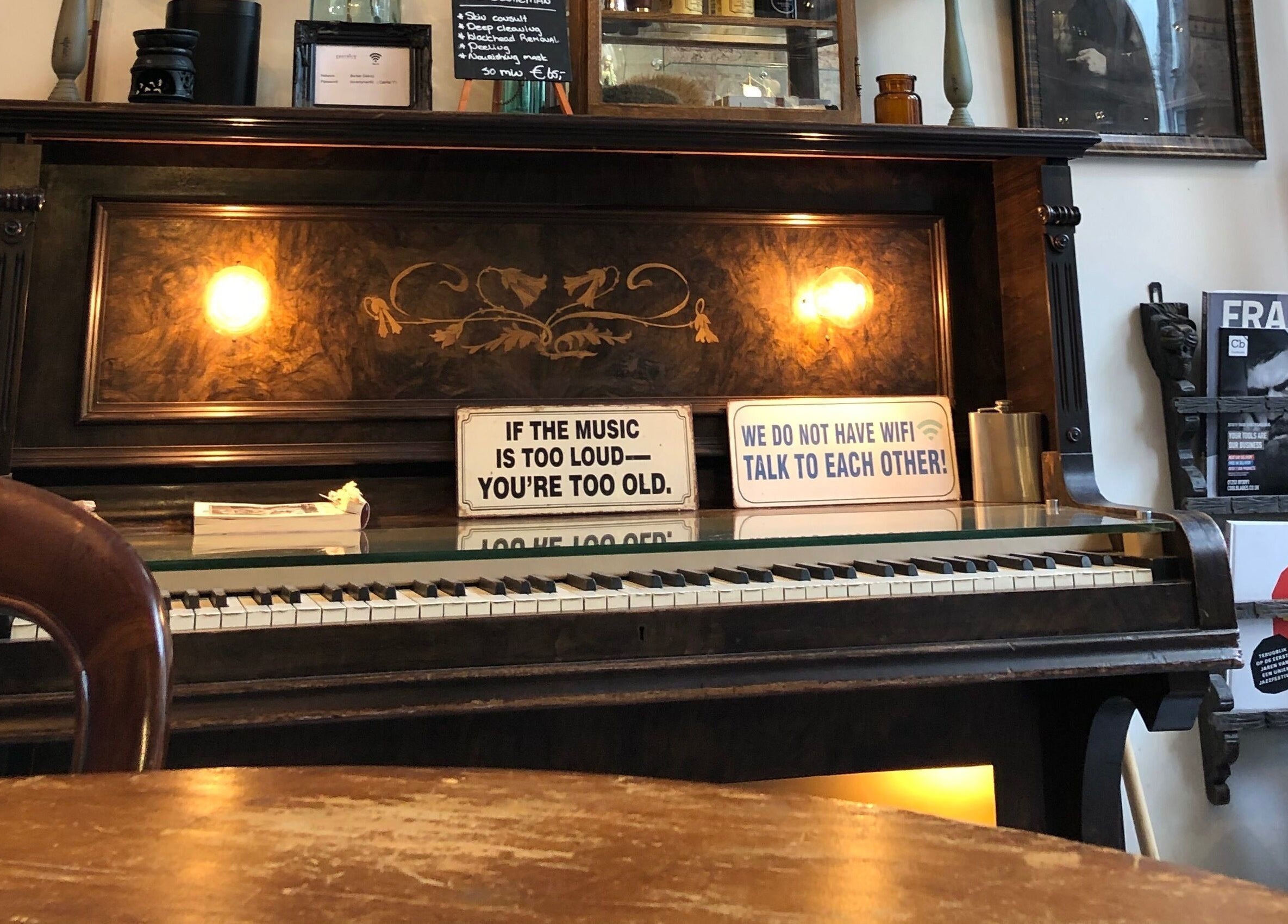 Cozy vintage piano inside Cutting Casper, Amsterdam, Noord-Holland, NL, creating a warm ambiance.