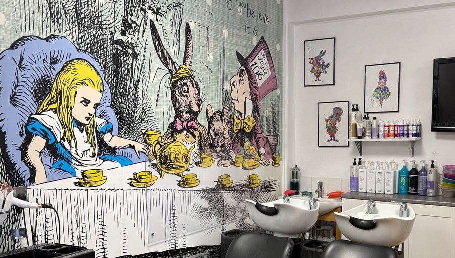 Alice in Wonderland mural at Mad Hatters Hairdressing, Stafford, England, GB with salon chairs and hair products.
