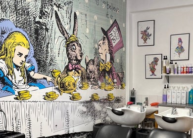 Alice in Wonderland mural at Mad Hatters Hairdressing, Stafford, England, GB with salon chairs and hair products.