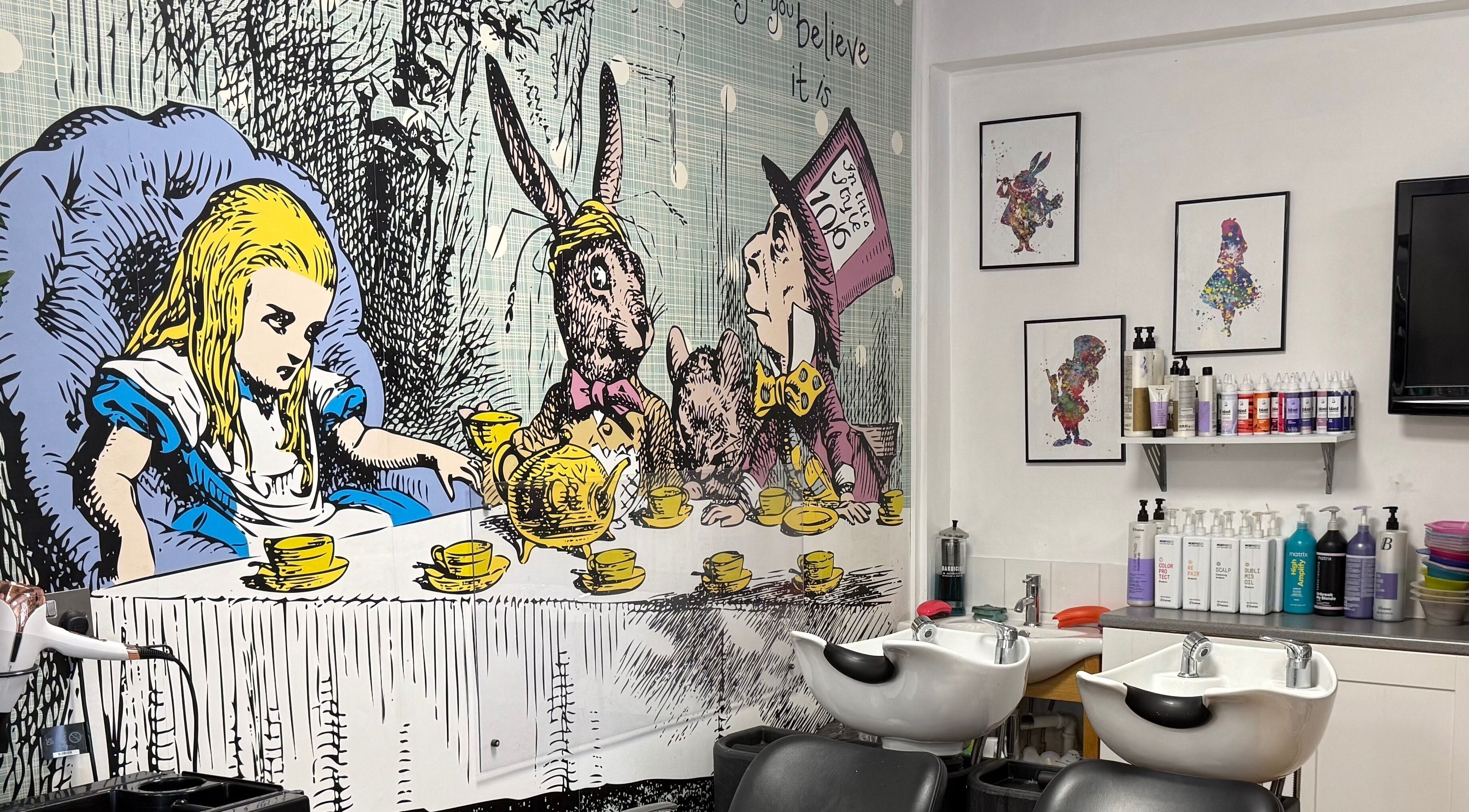 Alice in Wonderland mural at Mad Hatters Hairdressing, Stafford, England, GB with salon chairs and hair products.