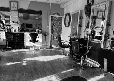 Interior of Mad Hatters Hairdressing in Stafford, England, with stylish chairs and mirrors.