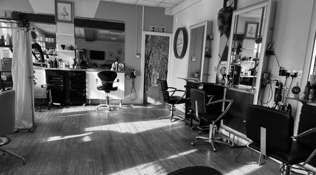 Interior of Mad Hatters Hairdressing in Stafford, England, with stylish chairs and mirrors.