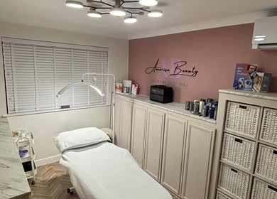 Relaxing treatment room at Amarisa Beauty, Berwick, England, GB, featuring a cozy bed and stylish lighting.
