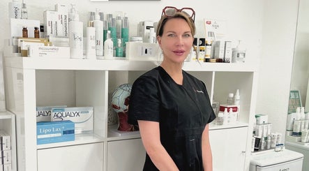 Beauty specialist at iBeautify, Royal Tunbridge Wells, GB, with skincare products display.