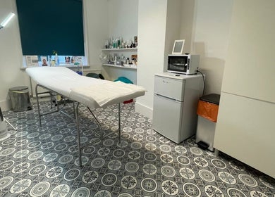Relaxing treatment room at iBeautify in Royal Tunbridge Wells, GB with a comfortable bed and modern decor.