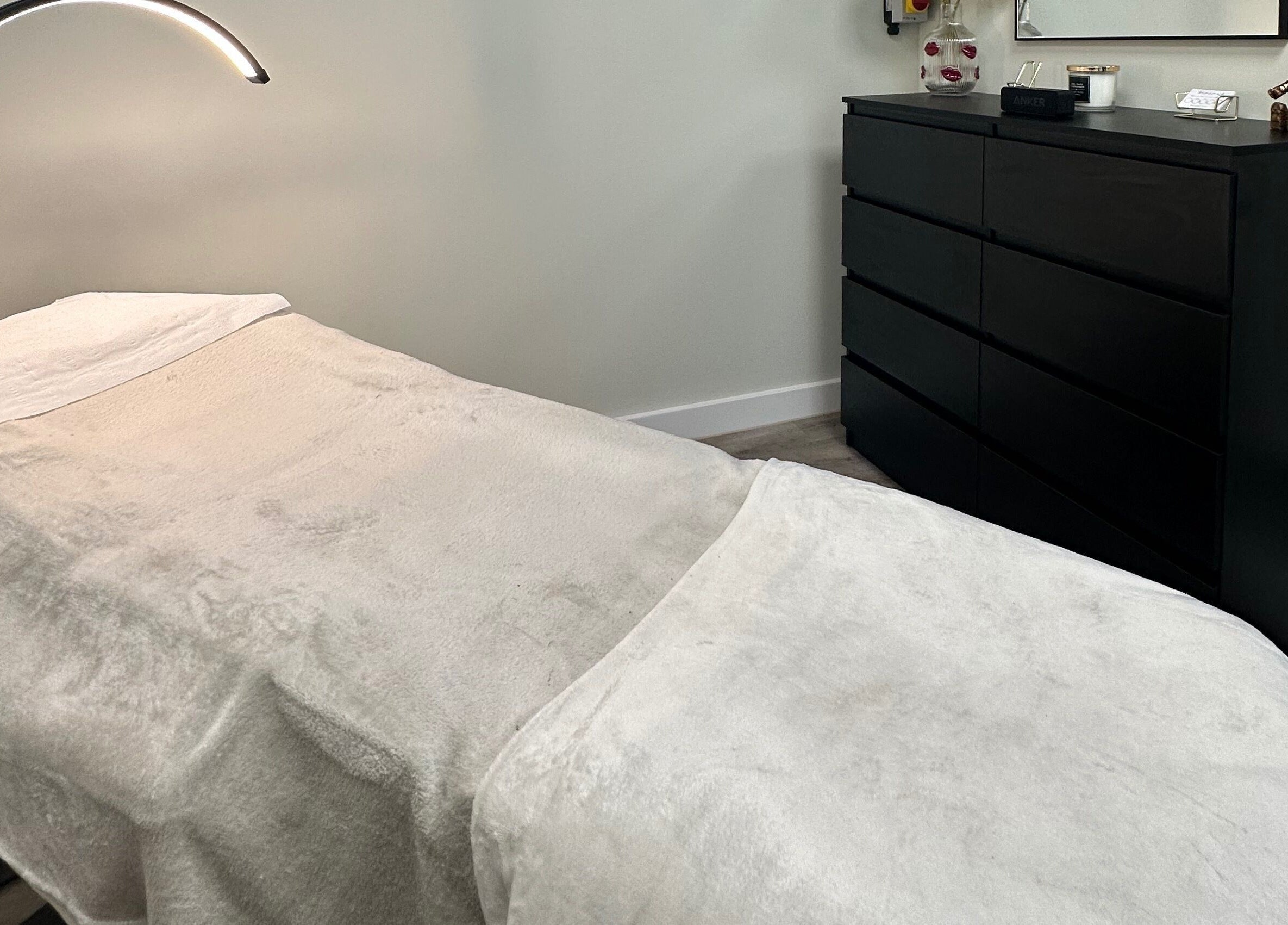 Cozy treatment room at Dolled Up by Alex, Hadleigh, England, GB, showcasing a comfortable massage bed.