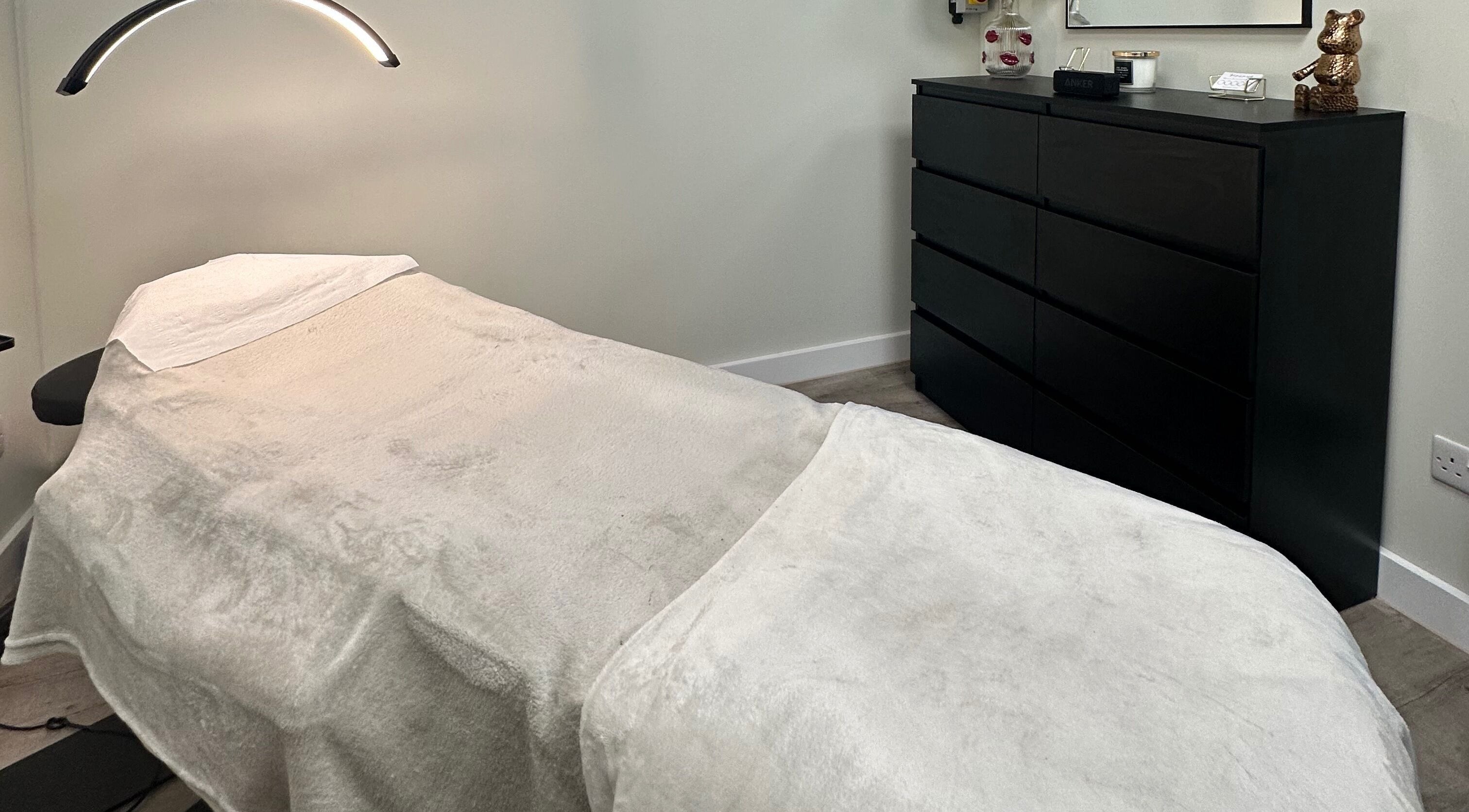 Cozy treatment room at Dolled Up by Alex, Hadleigh, England, GB, showcasing a comfortable massage bed.