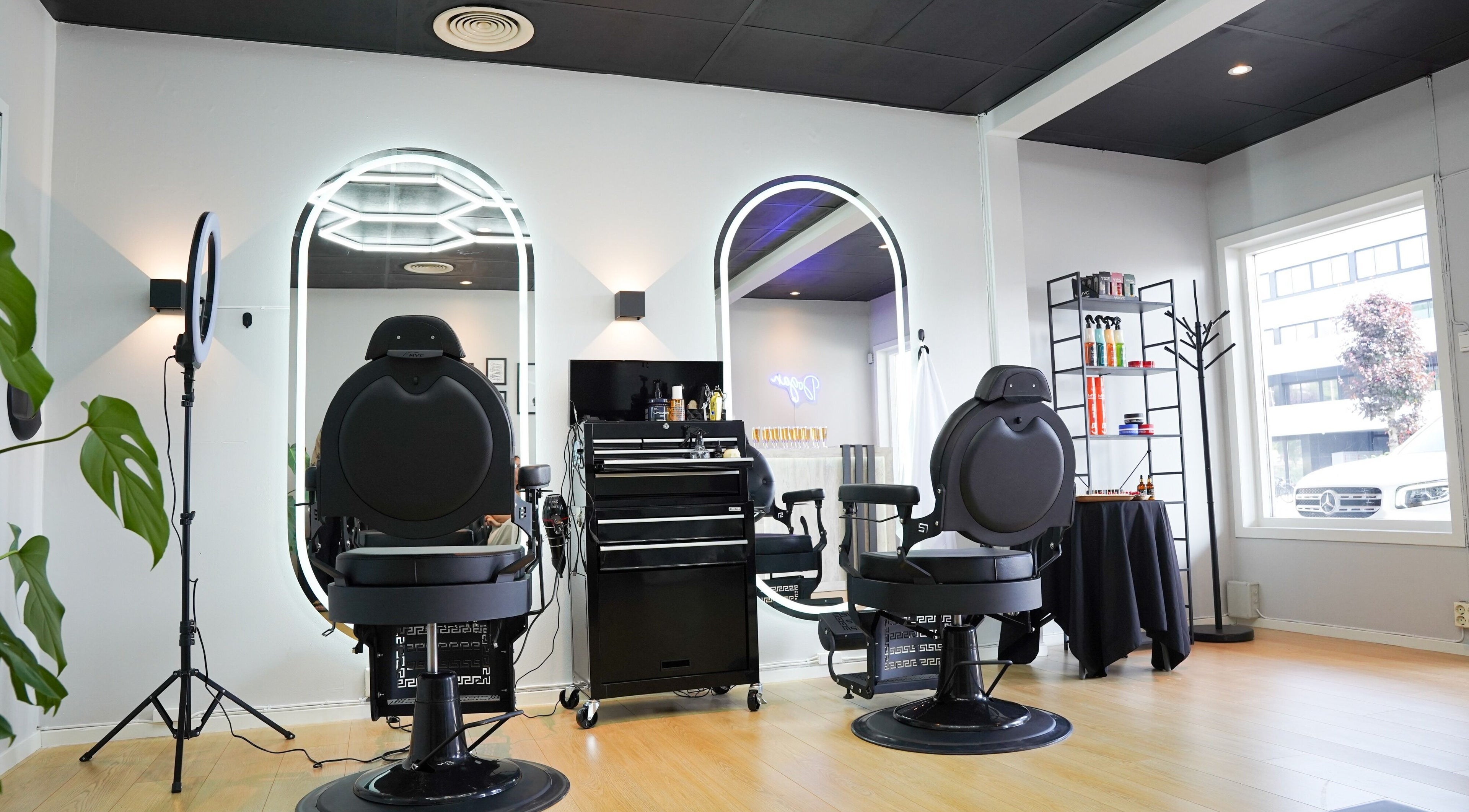 Sleek interior of Dogan Barbershop in Stavanger, Rogaland, NO, featuring stylish chairs and bright mirrors.