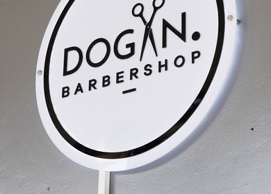Sign of Dogan Barbershop in Stavanger, Rogaland, NO, showcasing stylish branding.
