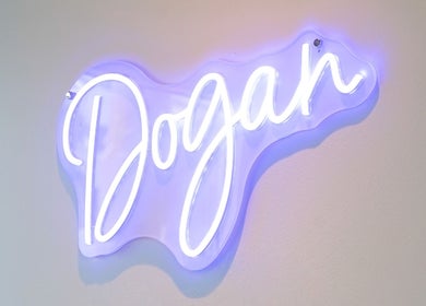 Illuminated Dogan Barbershop sign at Stavanger, Rogaland, NO, showcasing stylish decor.
