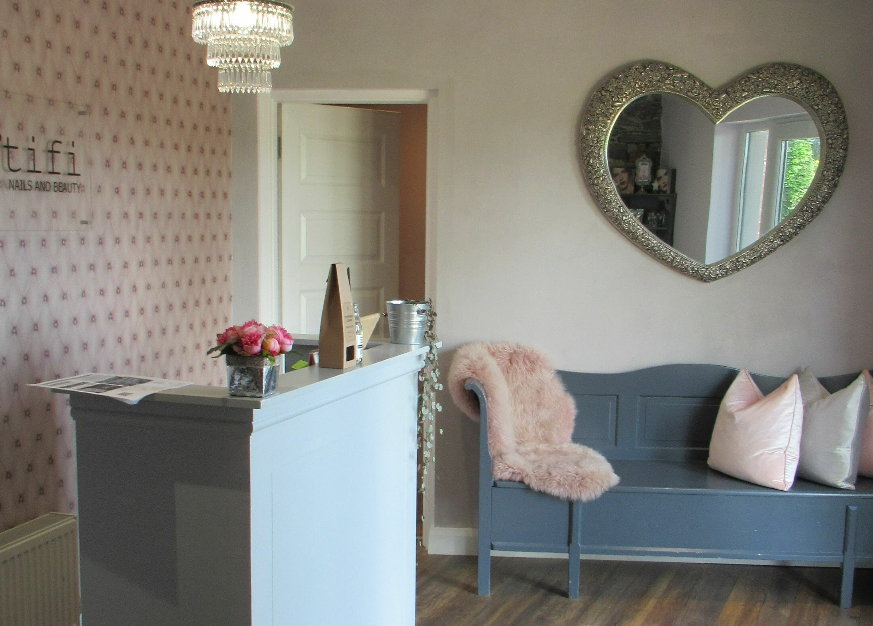 Elegant reception area at BeYOUtifi, Donaghadee, Northern Ireland, GB with heart-shaped mirror and stylish seating.