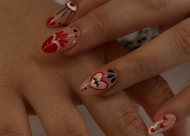 Stylish manicure with red heart designs at Summer Nail Club, Leigh-on-sea, England, GB.