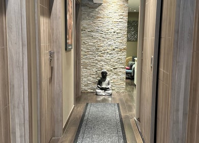 Peaceful corridor with Buddha at Esthetique Head Spa Weybridge, Weybridge, England, GB.