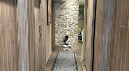 Peaceful corridor with Buddha at Esthetique Head Spa Weybridge, Weybridge, England, GB.
