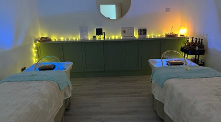 Relaxing massage room at Esthetique Head Spa Weybridge, Weybridge, England, GB with two cozy massage tables.