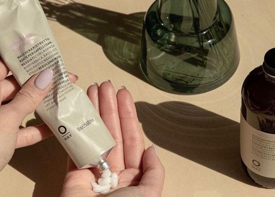 Hands using hair mask at Esthetique Head Spa Weybridge, Weybridge, England, GB. Enhance relaxation and wellness.