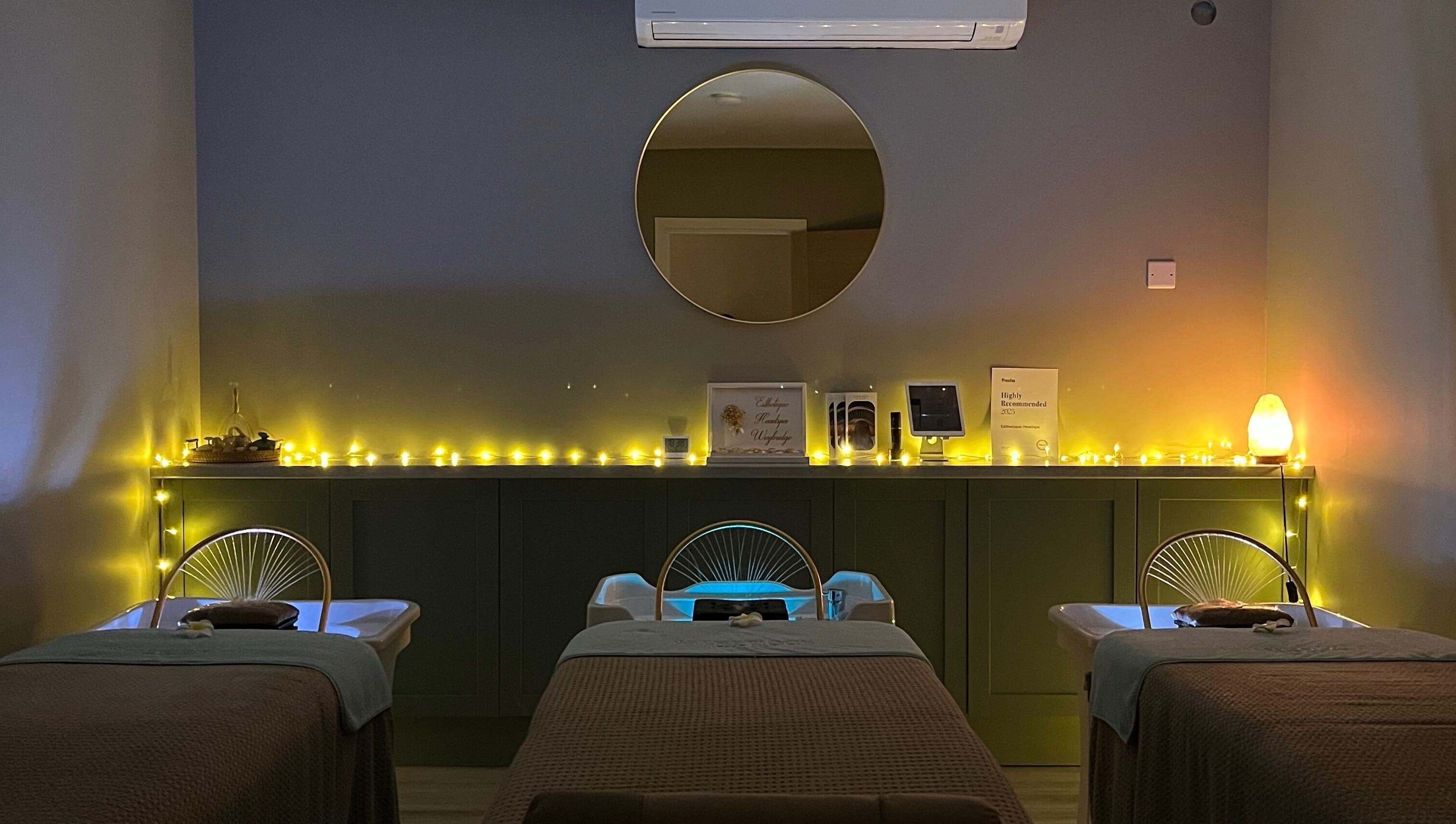 Peaceful treatment room at Esthetique Head Spa Weybridge, Weybridge, England, GB, with ambient lighting.