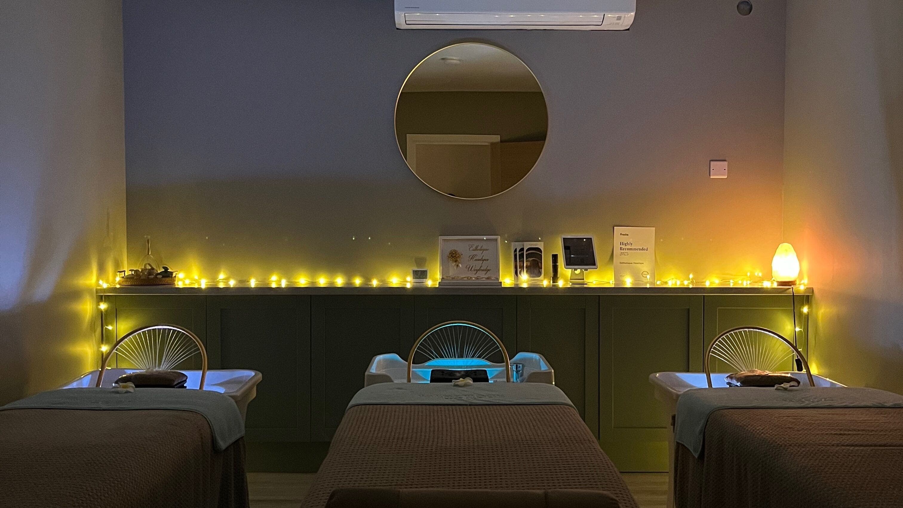 Peaceful treatment room at Esthetique Head Spa Weybridge, Weybridge, England, GB, with ambient lighting.